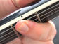 Pressing down near the frets eliminates the possibility of fret-buzz